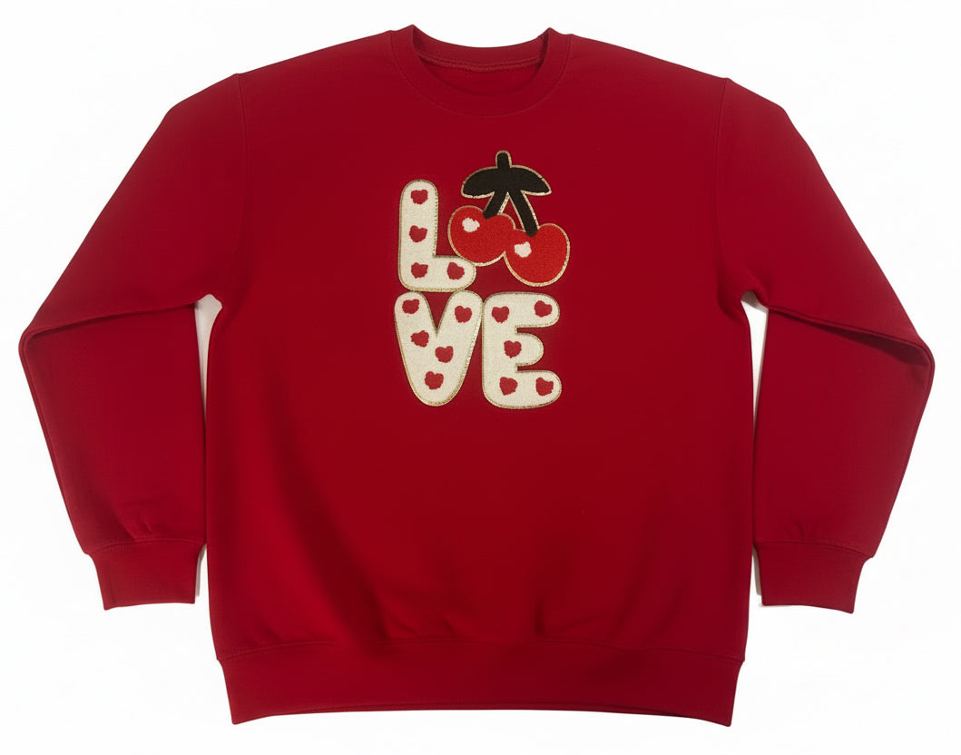 Red sweatshirt with 'LOVE' and cherry design on a white background